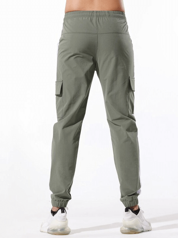 Model wearing Casual Sports Pants for Men with large side pockets, elastic waistband, and secure fit, ideal for running and exercise SF1520.